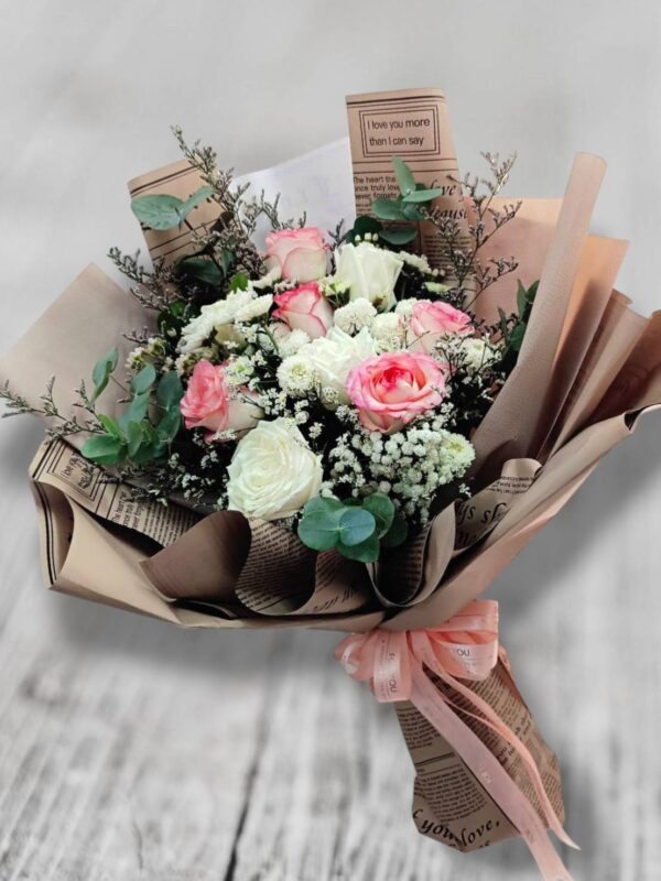 Bouquet of white and pink roses, decorated with brown paper