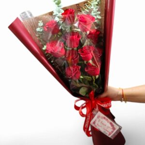 11 long-stemmed red roses, including decorations