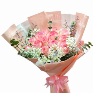 A bouquet of 15 pink roses arranged in a circle.