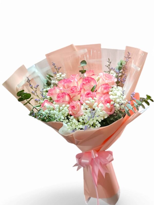A bouquet of 15 pink roses arranged in a circle.
