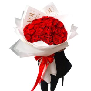 A bouquet of 51 large red roses, decorated with white or black paper.