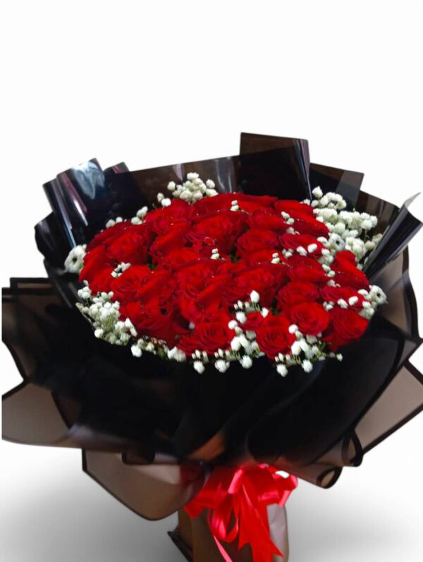 31 red roses wrapped in round black paper