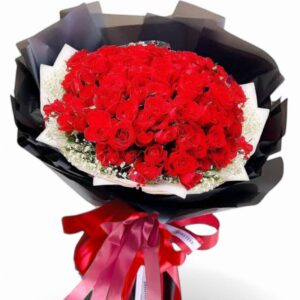 A bouquet of 51 red roses decorated with black paper.