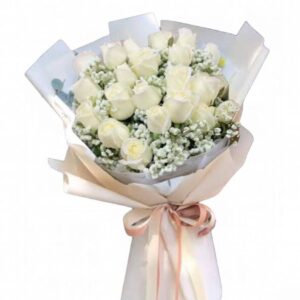 A bouquet of 19 long white roses, light colored paper