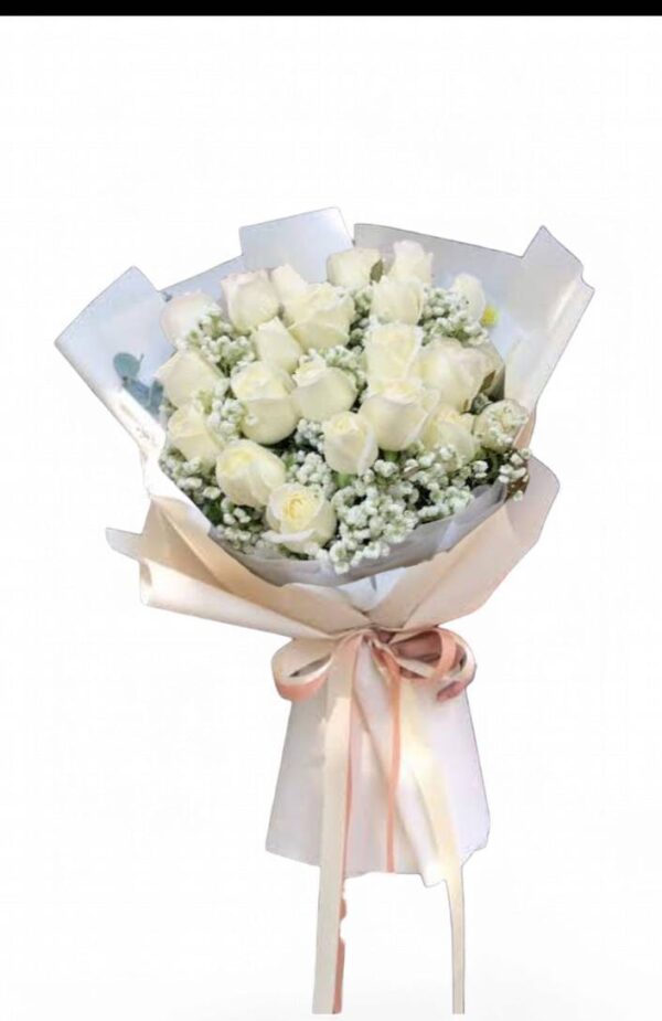 A bouquet of 19 long white roses, light colored paper