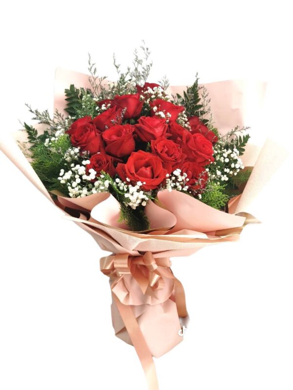A bouquet of 15 large red roses with pink paper edges