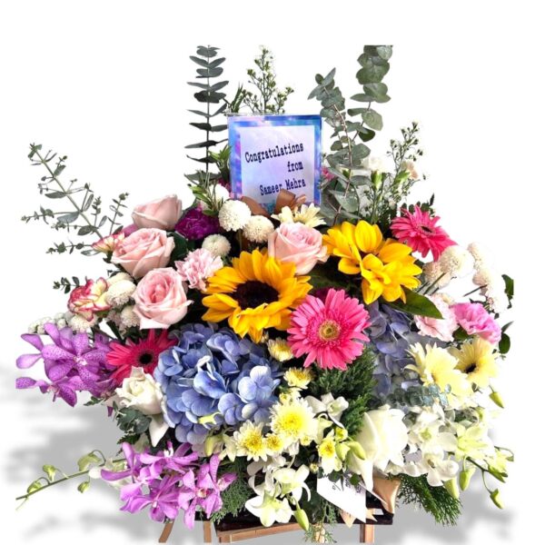 Multi-colored basket of hydrangeas, sunflowers, and gerberas