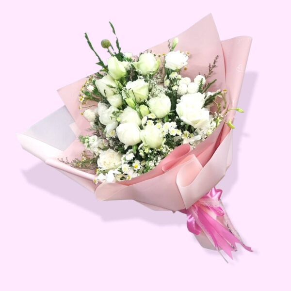 White roses, pink wrapping paper